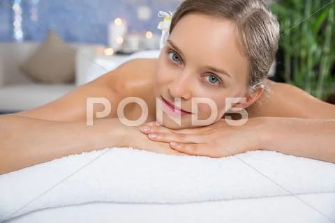Content young woman lying on massage table Stock Photos
