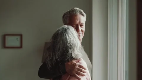 Contented elderly couple gaze out the window and at each other Stock Footage 254691014