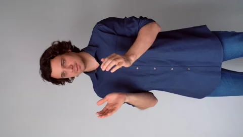Contented interested man clapping hands on gray background with copy space. Stock Footage 311876205