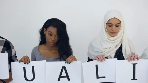 Contented modern multiethnic young workers standing on the white background and Stock Footage 122011531