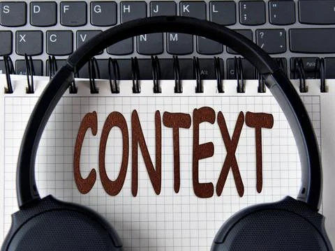 CONTEXT -word on white notepad with keyboard and headphone background Stock Photos