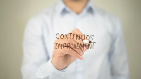 Continous Improvement, man writing on transparent screen Stock Photos