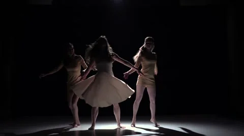Continue contemporary dance of three girls in white dresses, on black, shadow Video stock 61179413