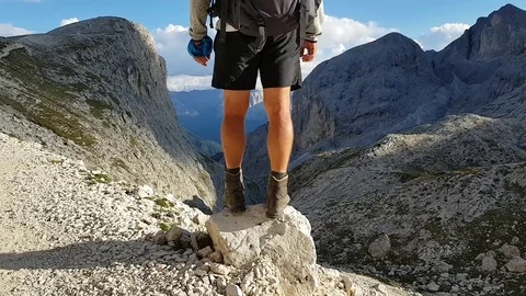 Continuing the hike in the Dolomites after a stop to enjoy the magnificent view. Stock Footage 97718226