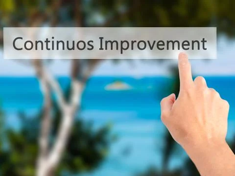 Continuos Improvement - Hand pressing a button on blurred background concept  Foto stock