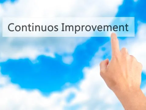 Continuos Improvement - Hand pressing a button on blurred background concept  Foto stock