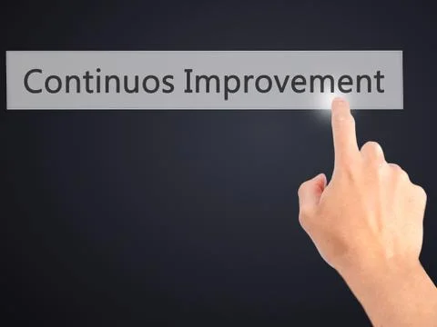 Continuos Improvement - Hand pressing a button on blurred background concept  Foto stock