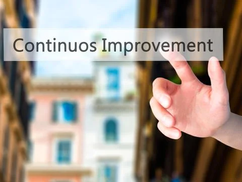 Continuos Improvement - Hand pressing a button on blurred background concept  Stock Photos