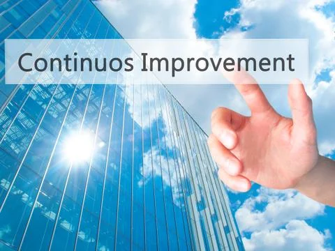 Continuos Improvement - Hand pressing a button on blurred background concept  Stock Photos