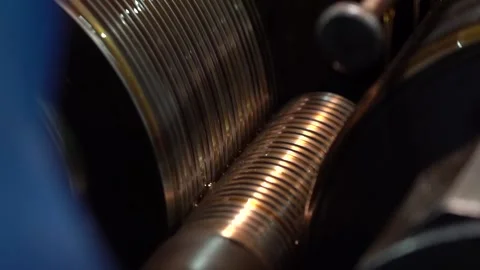 Continuous close up of helical threads being rolled onto a brass toned rod Video stock 345403707