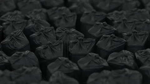 Continuous counterclockwise rotation of filled black packing bags. Depth of Stock Footage 149768847