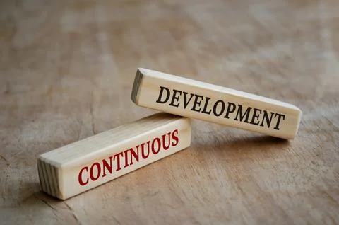 Continuous development text on wooden blocks. Development concept Stock Photos