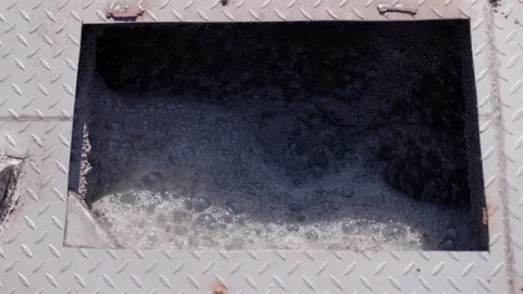 Continuous flow of bubbling wastewater in a sewage treatment plant, showcasing Stock Footage 319537140