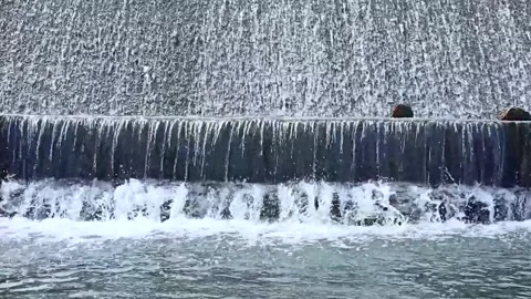 Continuous flow of water cascading over a small stone weir creating white s.. Stock Footage 332500798