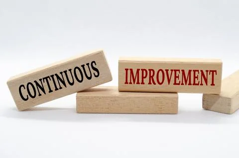 Continuous improvement text on wooden blocks. Business culture and Operatio.. Stock Photos