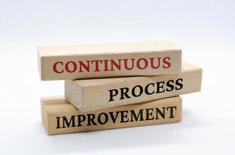 Continuous process improvement text on wooden blocks. Business culture and Stock Photos