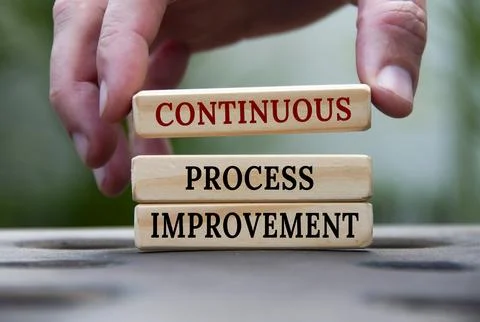 Continuous process improvement text on wooden blocks with blurred nature ba.. Stock Photos