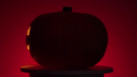 Continuous rotation of halloween pumpkin with glowing fanar inside Video stock 163155098