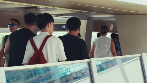 A continuous scene featuring individuals moving through a sleek, contemporary Stock-Footage 338311440