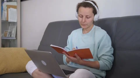 Continuous self-education during covid-19 lockdown. Self-isolating woman takes Stock Footage 142930292
