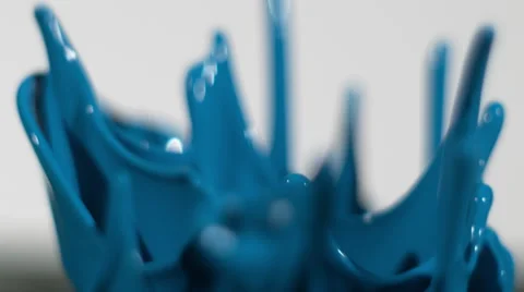 Continuous splashes of blue paint isolated on white in slow motion Video stock 64000383