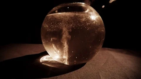 Continuous Stream of White Bubbles Rises up in Glassware About Moving Hands in t Stock Footage