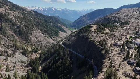 Continuous Tracking Flight Over High Mountain Plateau and Alpine Resort Stock Footage 339381253