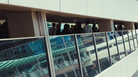 A continuous upward shot of a modern multi-level pedestrian walkway in bustling Stock Footage 338311444