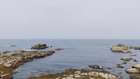 A continuous view of the rugged rocky shoreline and the Atlantic Ocean at Cote Stock Footage 346665536
