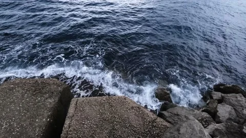 Continuously changing sea or ocean surface, breaking waves on rocks Stock Footage 233999803