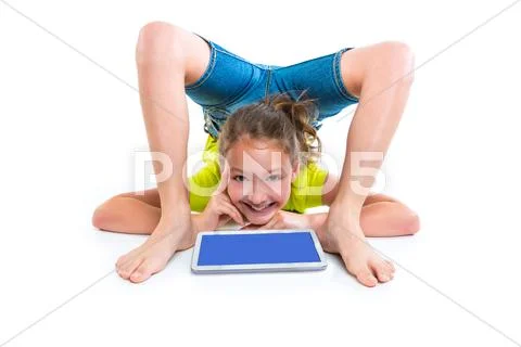 Contortionist kid girl thinking gesture with tablet pc Stock Photos