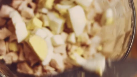 Contour effect of Cut boiled eggs into rings with a knife on a wooden board Stock Footage 240632653