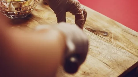 Contour effect of Cut boiled eggs into rings with a knife on a wooden board Stock Footage 240632782