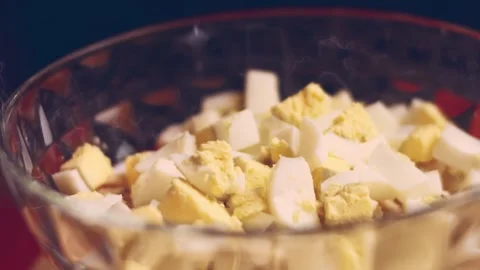 Contour effect of Cut boiled eggs into rings with a knife on a wooden board Stock Footage 240632878