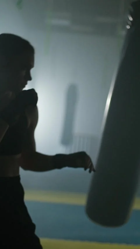 Contour light, pro fighter beats and trains his punches, hard training day in Stock Footage 329221063