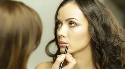 Contouring lips with white pencil Stock Footage 63043273