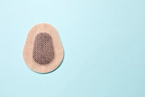 Contraceptive patch on light blue background, top view. Space for text Stock Photos