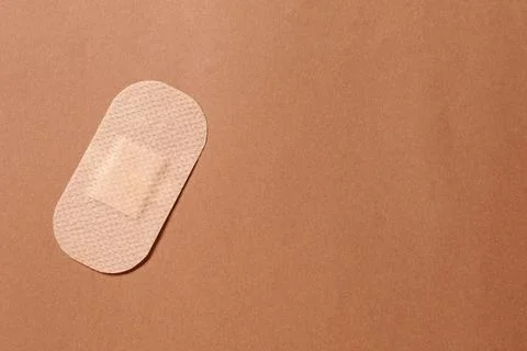 Contraceptive patch on light brown background, top view. Space for text Stock Photos