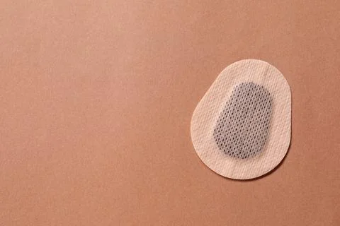 Contraceptive patch on light brown background, top view. Space for text Stock Photos