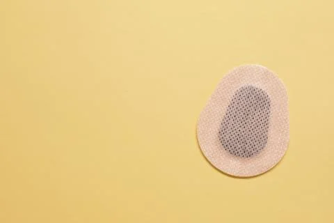 Contraceptive patch on yellow background, top view. Space for text Stock Photos