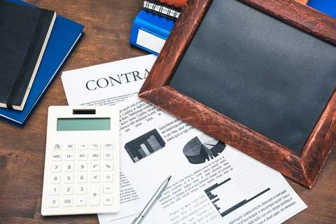 Contract and calculator at workplace Stock Photos