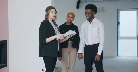 With contract and house plan in hand, the confident blonde real estate agent Stock Footage 274739031