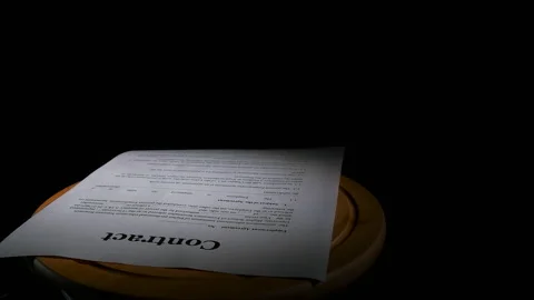 Contract docs on table on black background. Stock Footage 262623619