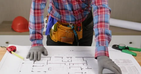 Contractor comes to table with prepared building floor plan 動画素材 277185855