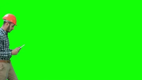 Contractor engineer in hardhat inspecting construction site holding digital Vídeo Stock 71203951