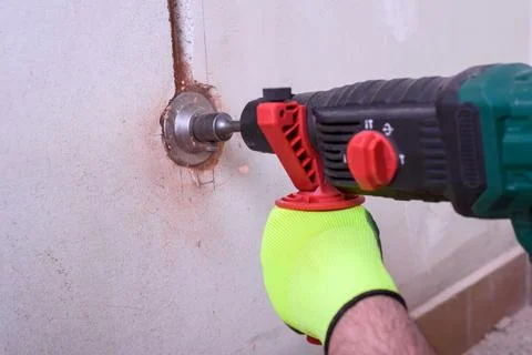 Contractor with hammer drill doing hole for socket Stock Photos