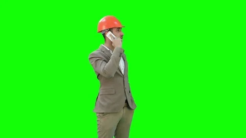 Contractor in hardhat talking on his cell phone on a Green Screen, Chroma Key Stock Footage 71203535