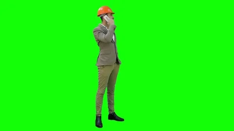 Contractor in hardhat talking on mobile phone on a Green Screen, Chroma Key Stock Footage 71204988