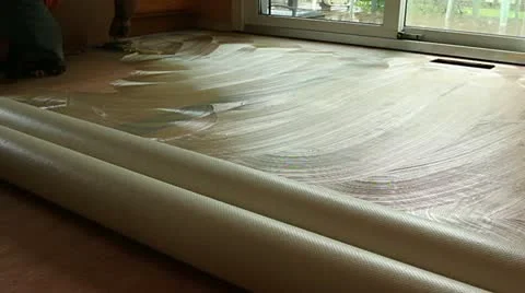 Contractor installing glue base for new flooring 動画素材 12392148