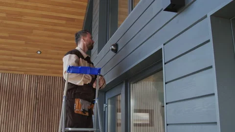 Contractor Installing Home Security Camera Stock Footage 156377233